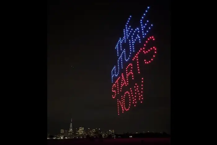 A photo of a drone light show, believed to be NYC's first, that lit up the night sky in June